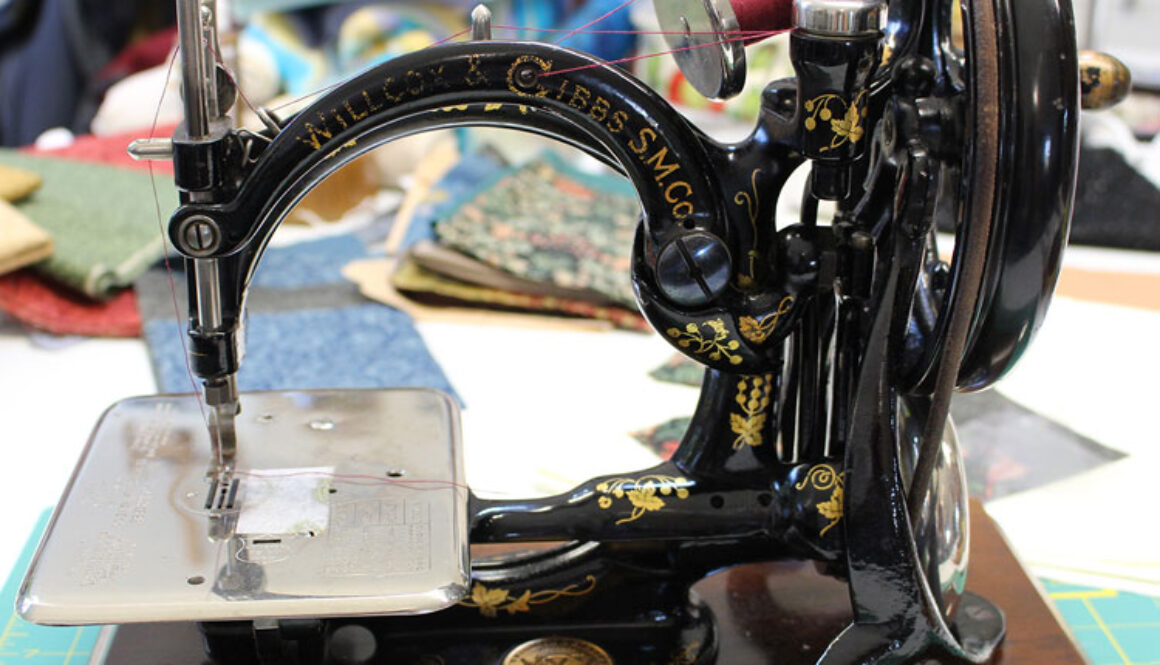 ewing with a Willcox & Gibbs Sewing Machine
